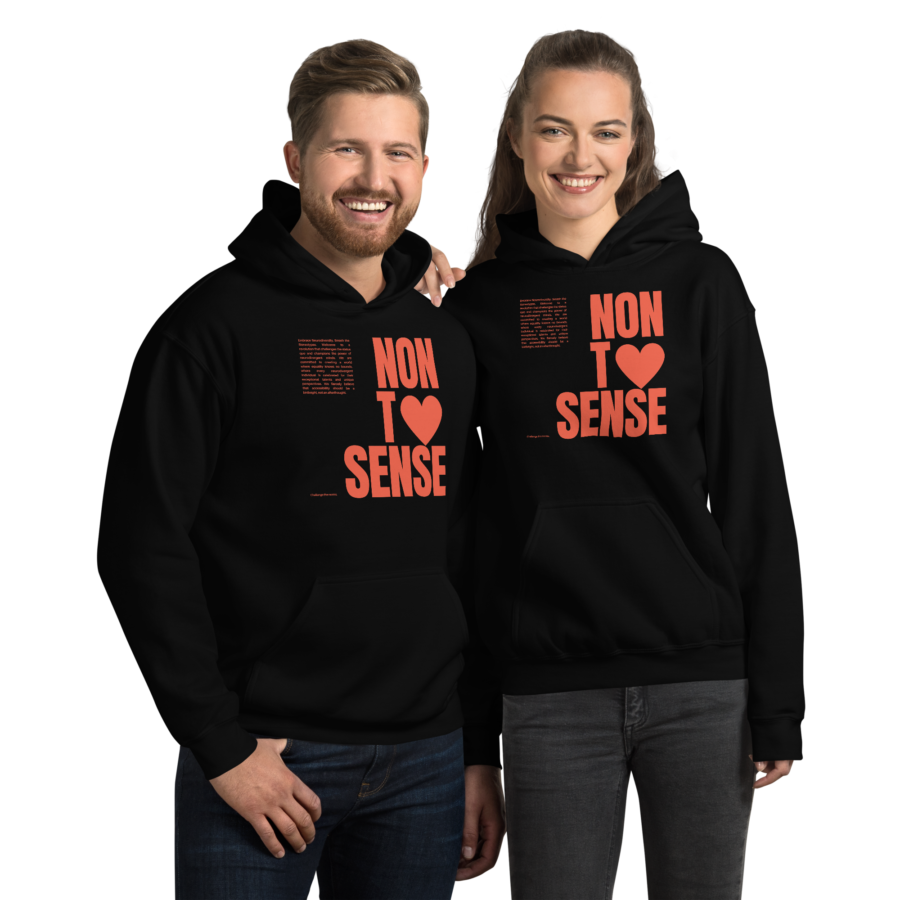 A man & a woman standing next to each other smiling. Both are wearing the black revolution hoodie.